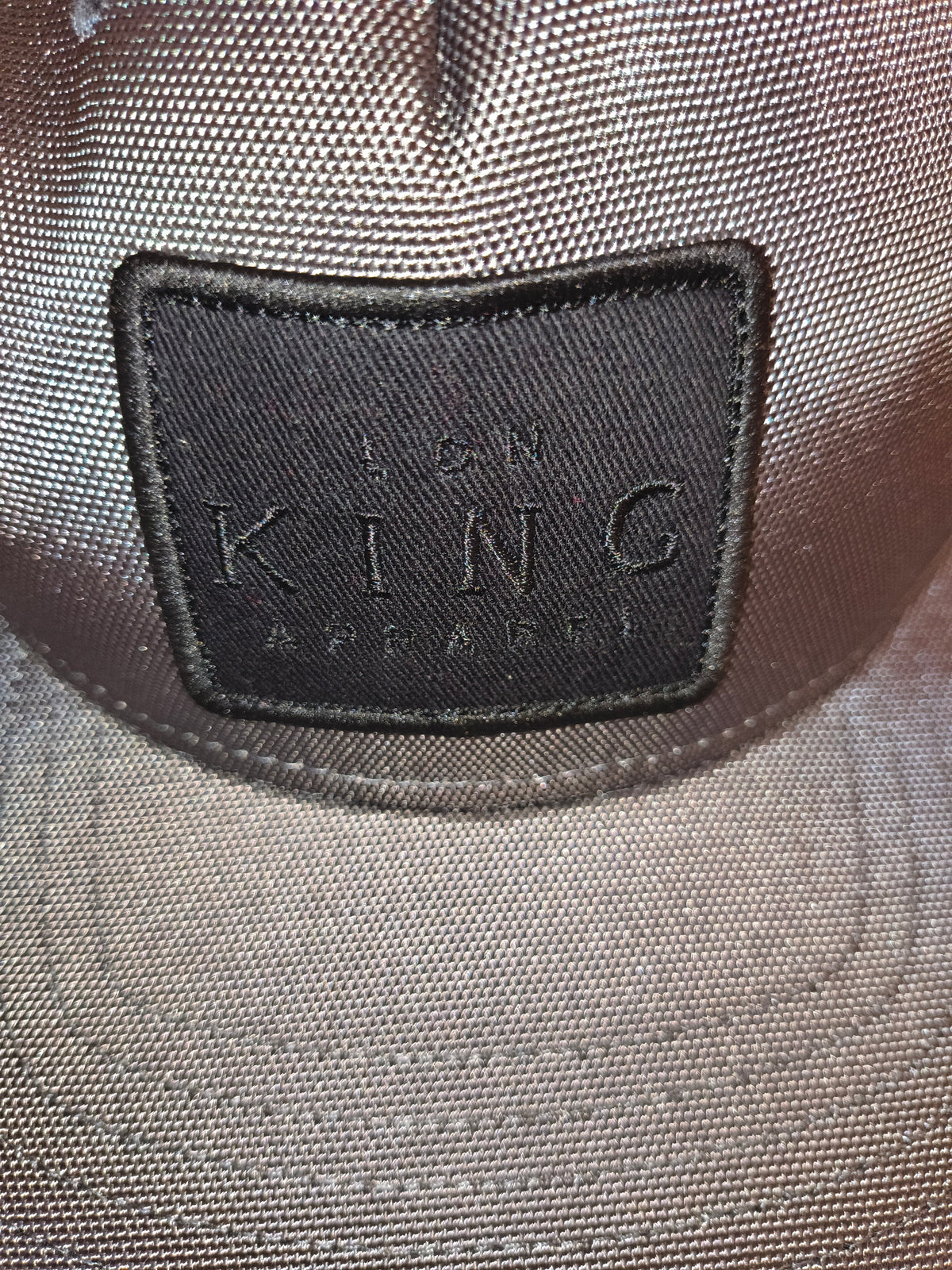 Awsum Thrift grey King Apparel trucker hat with a black rectangular patch logo on the front crown