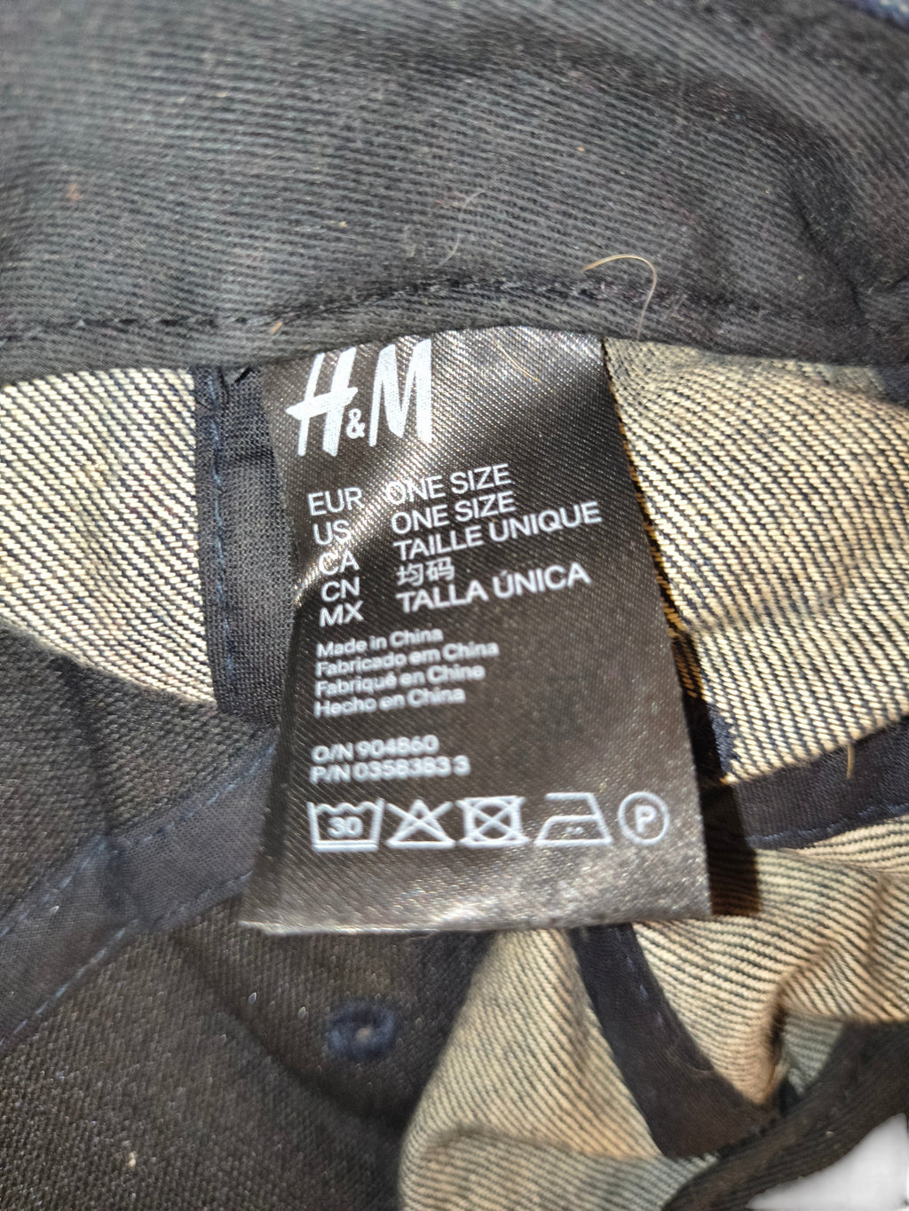 Awsum Thrift H&M denim snapback hat interior care label showing one size and manufacturing details
