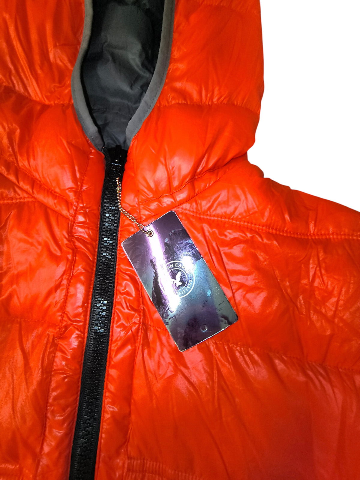 Awsum Thrift American Eagle Outfitters neon orange hooded down puffer jacket with charcoal gray lining and retail tag