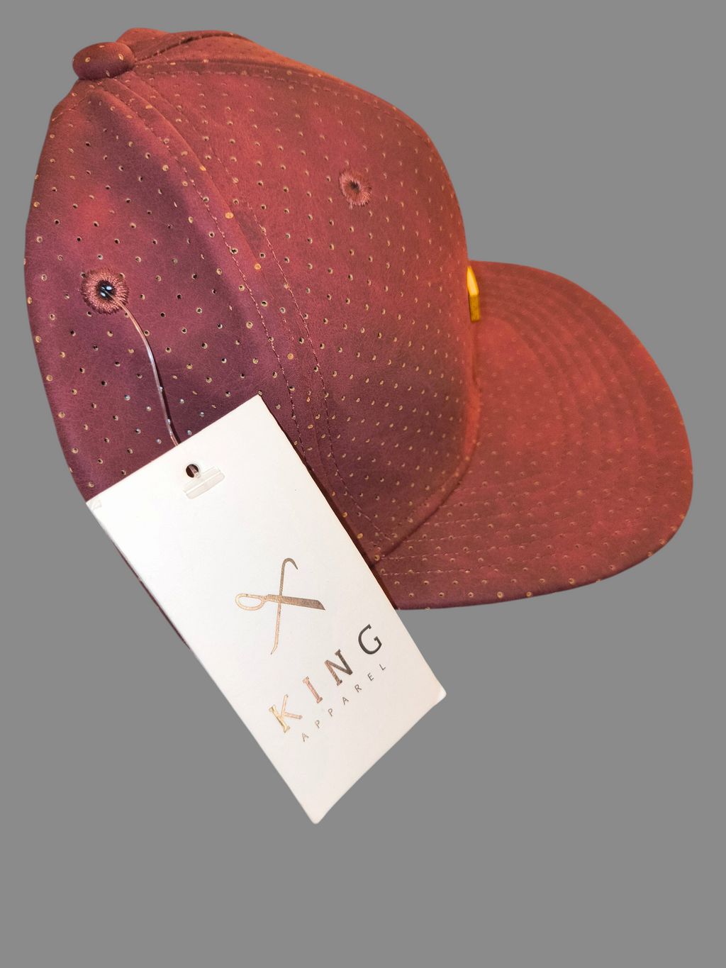 Awsum Thrift King Apparel maroon perforated faux-leather snapback hat with gold metal logo plate and brand tag