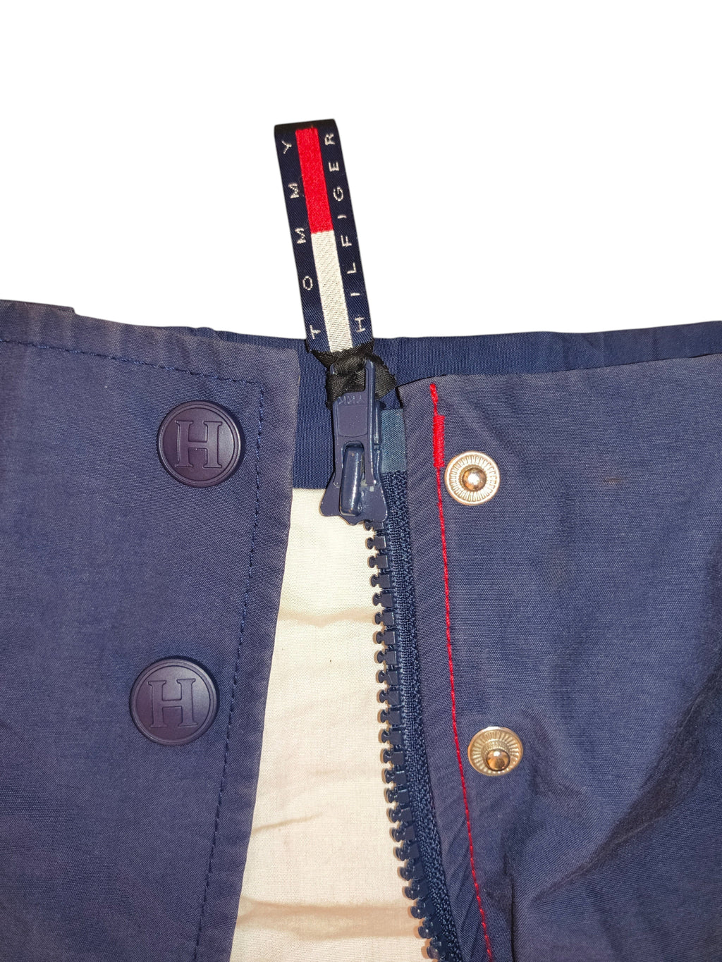Awsum Thrift vintage Tommy Hilfiger jacket in navy blue with branded zipper pull and hideaway hood detail