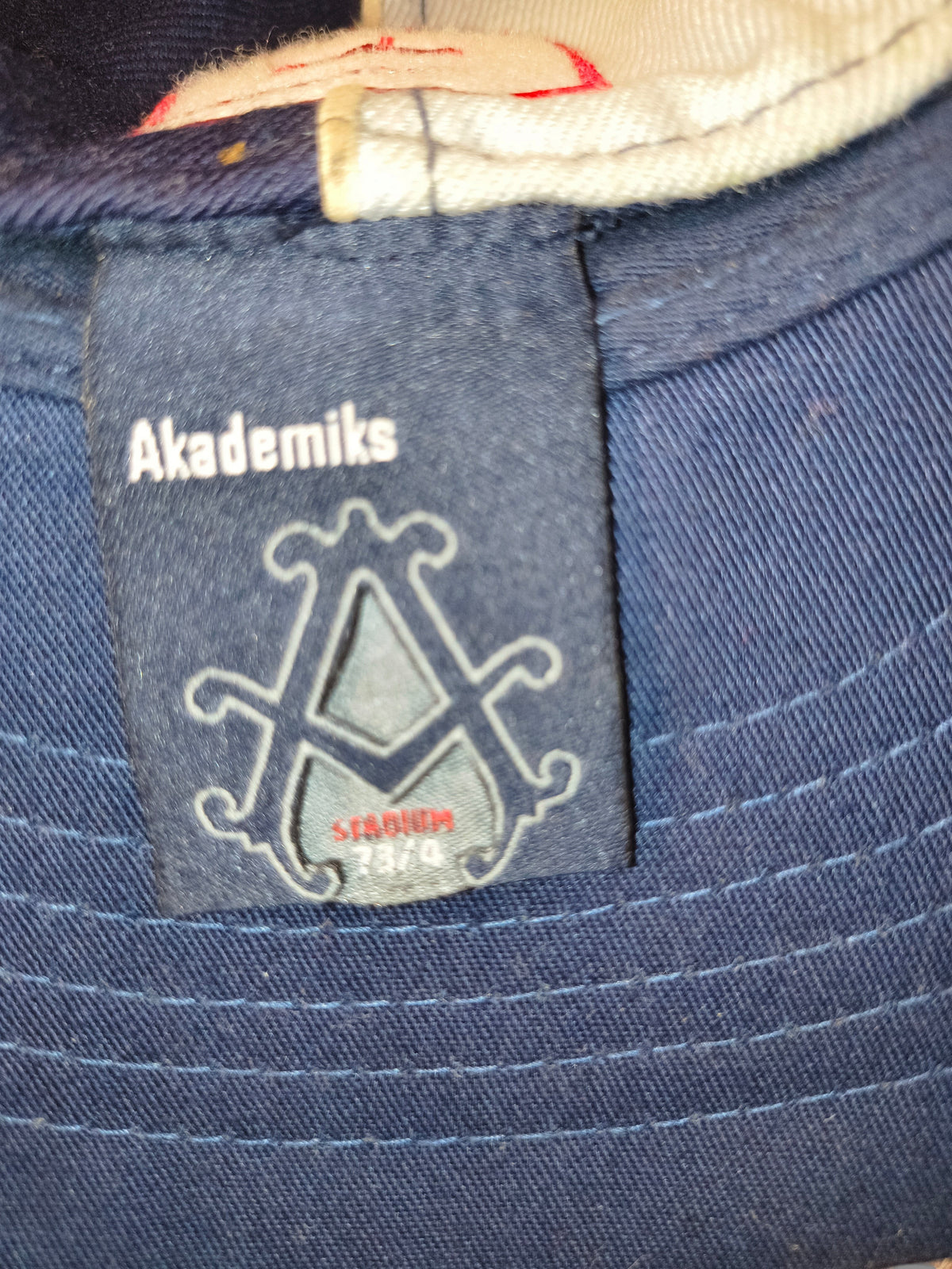 Awsum Thrift vintage Akademiks Stadium fitted hat interior tag showing brand logo and size 7 3/8 on navy fabric