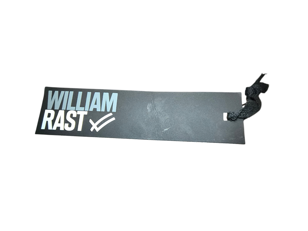 Awsum Thrift William Rast brand clothing tag with white logo on a black rectangular paper label