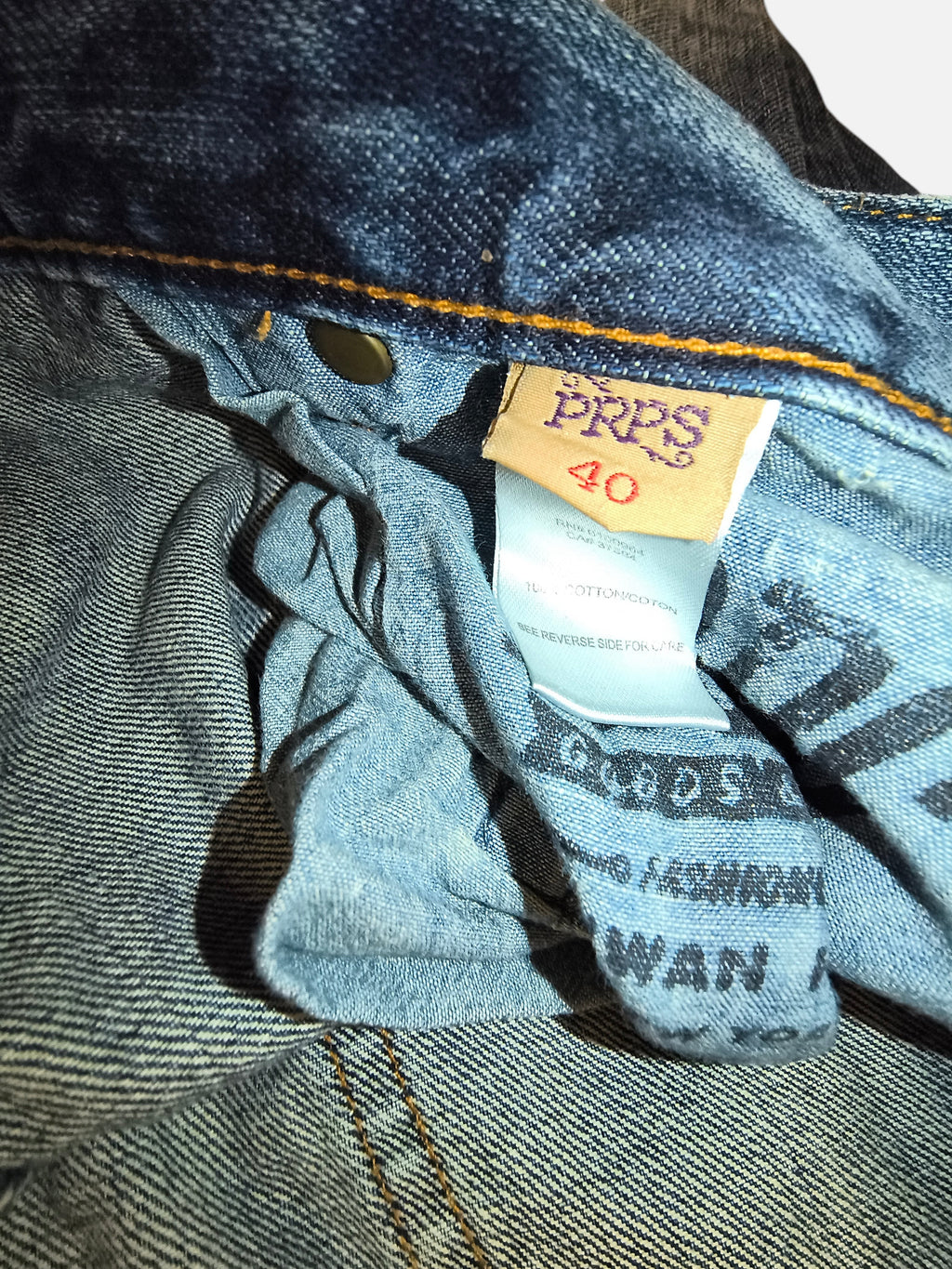 Awsum Thrift PRPS denim shorts interior label showing size 40 and 100 percent cotton material