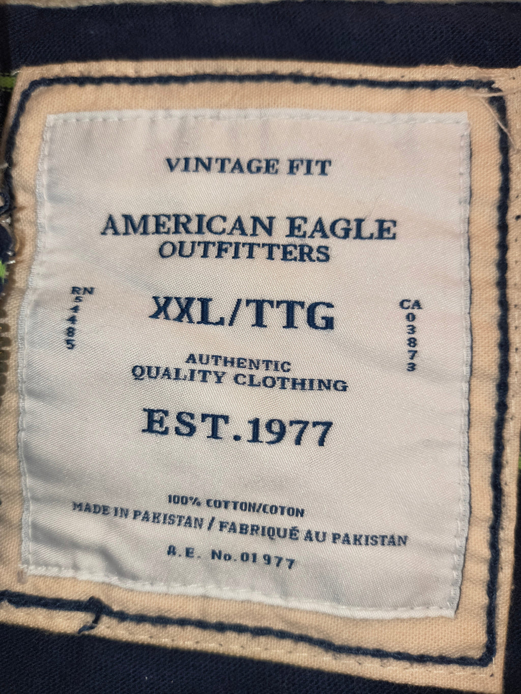 Awsum Thrift American Eagle Outfitters Vintage Fit XXL clothing label with navy blue text on a cream fabric patch