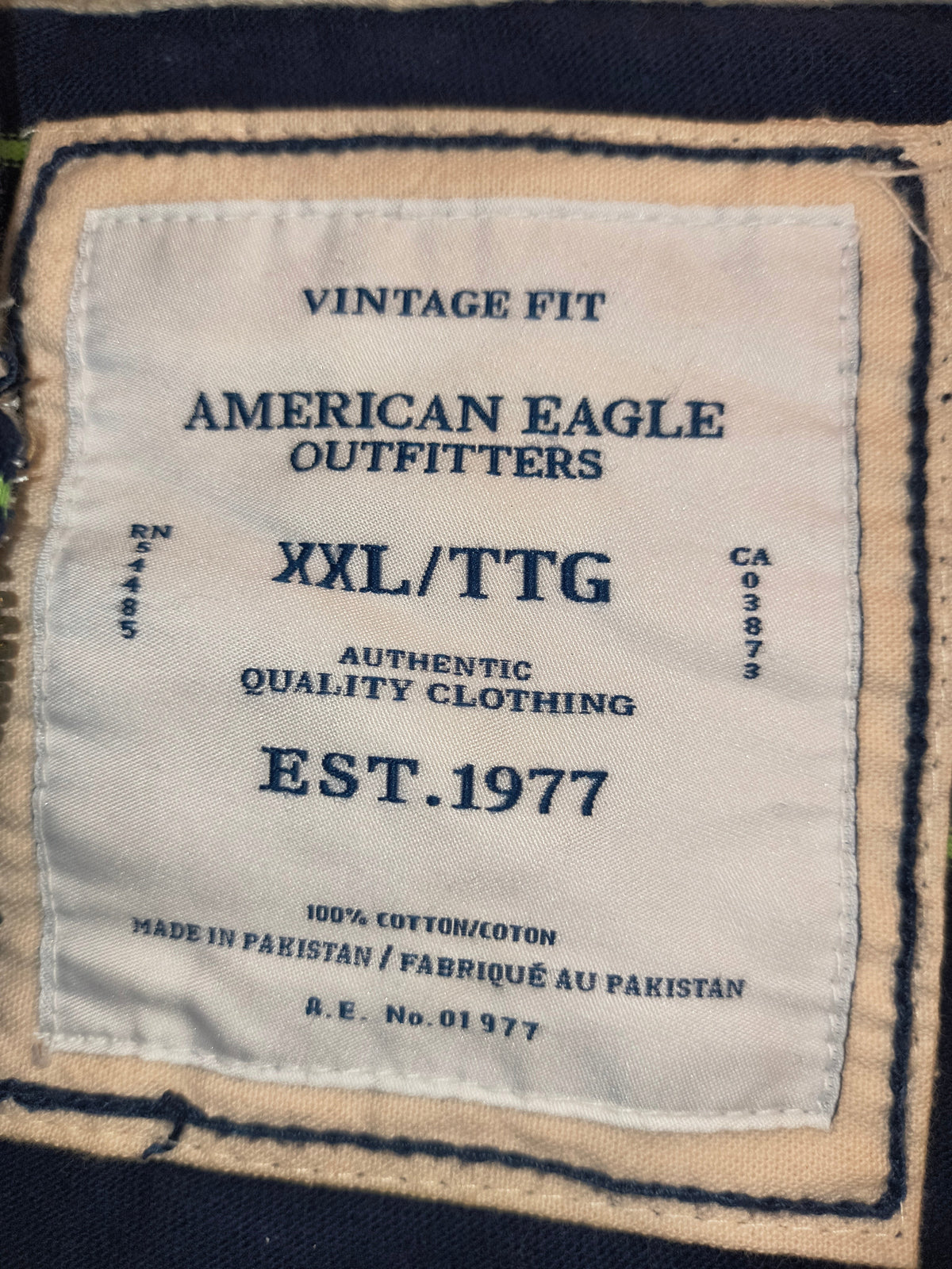 Awsum Thrift American Eagle Outfitters Vintage Fit XXL clothing label with navy blue text on a cream fabric patch