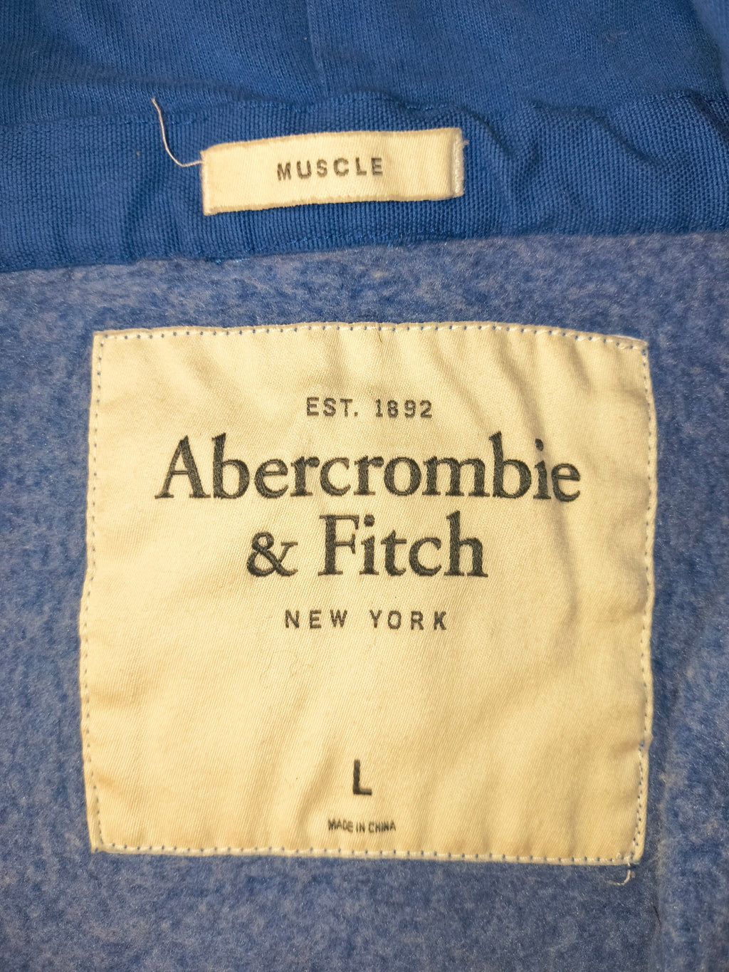 Awsum Thrift Abercrombie & Fitch vintage muscle fit hoodie interior brand and size label on heather blue fleece