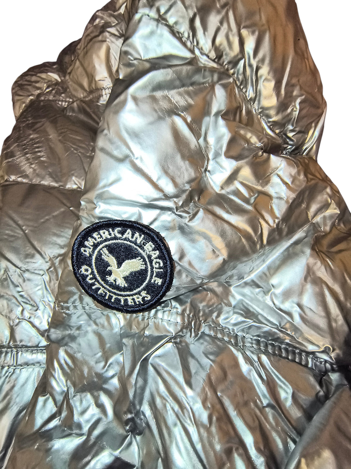 Awsum Thrift American Eagle metallic silver foil puffer jacket with circular logo patch on the sleeve