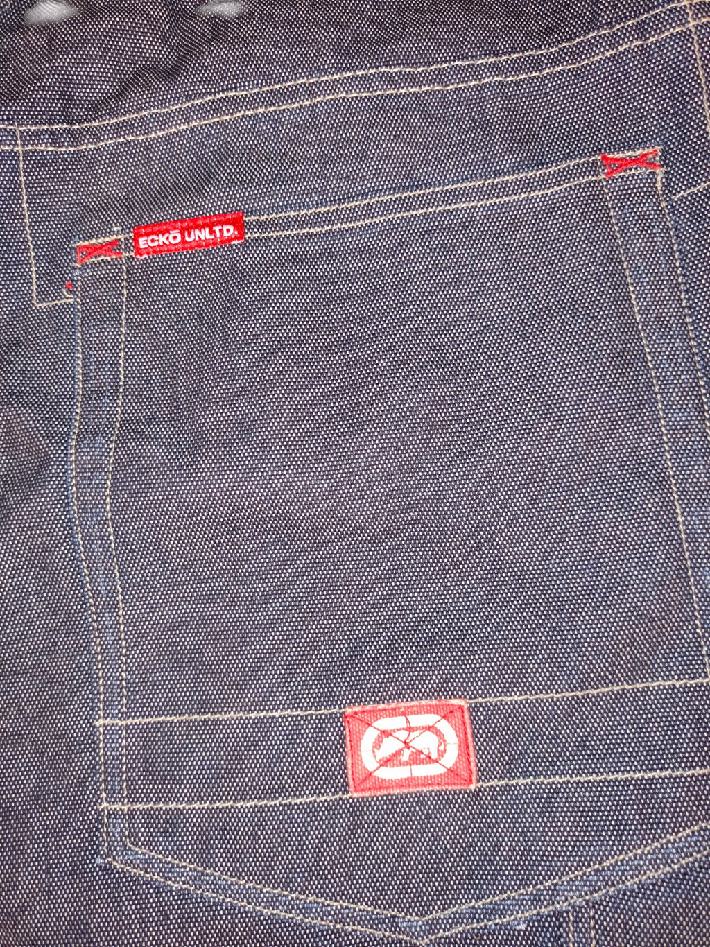 Awsum Thrift vintage Marc Ecko dark indigo raw denim jeans pocket with red contrast stitching and rhino logo embroidery