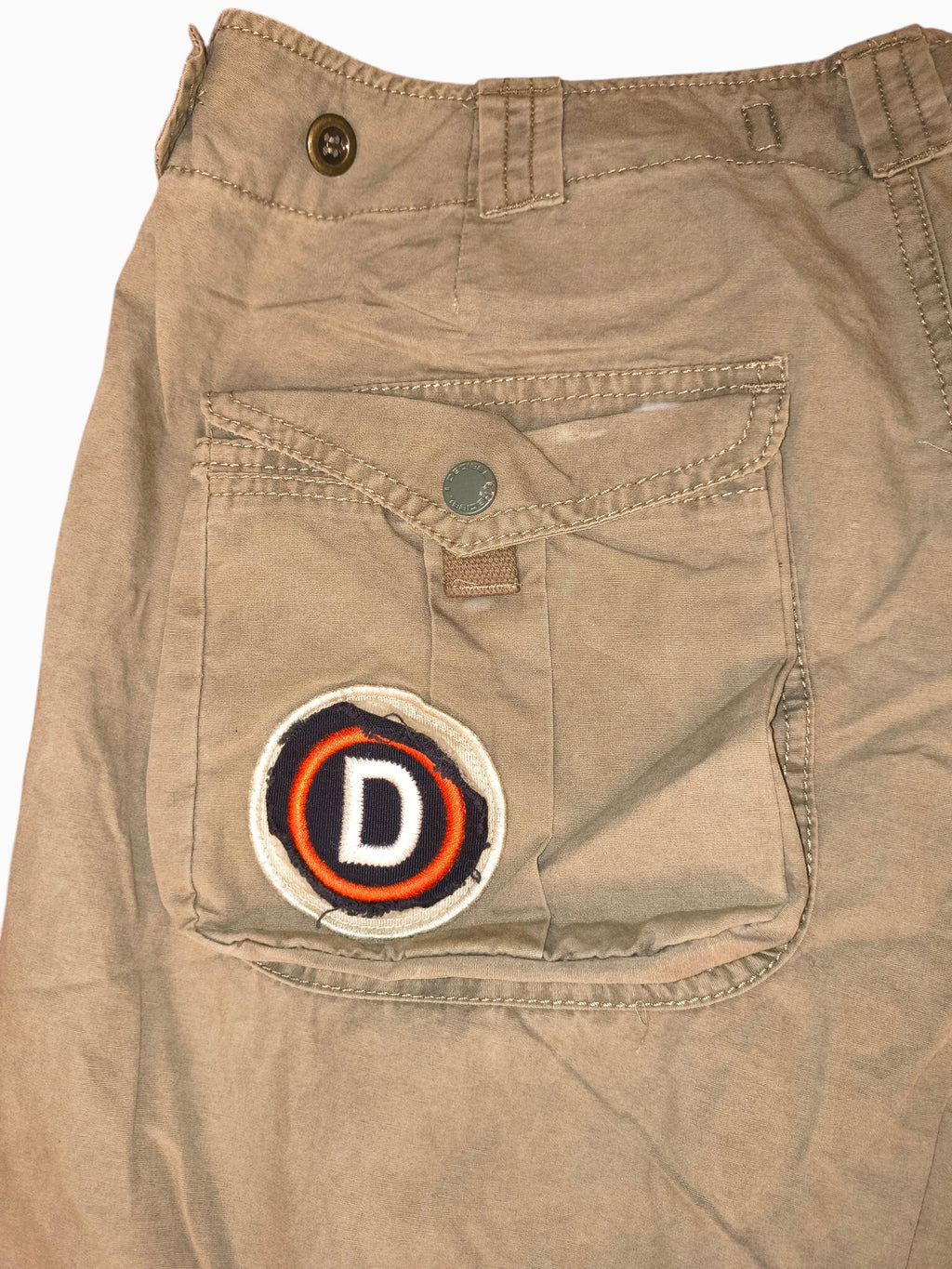 Awsum Thrift Decibel khaki cotton tactical cargo pants featuring a circular embroidered D patch on the side pocket