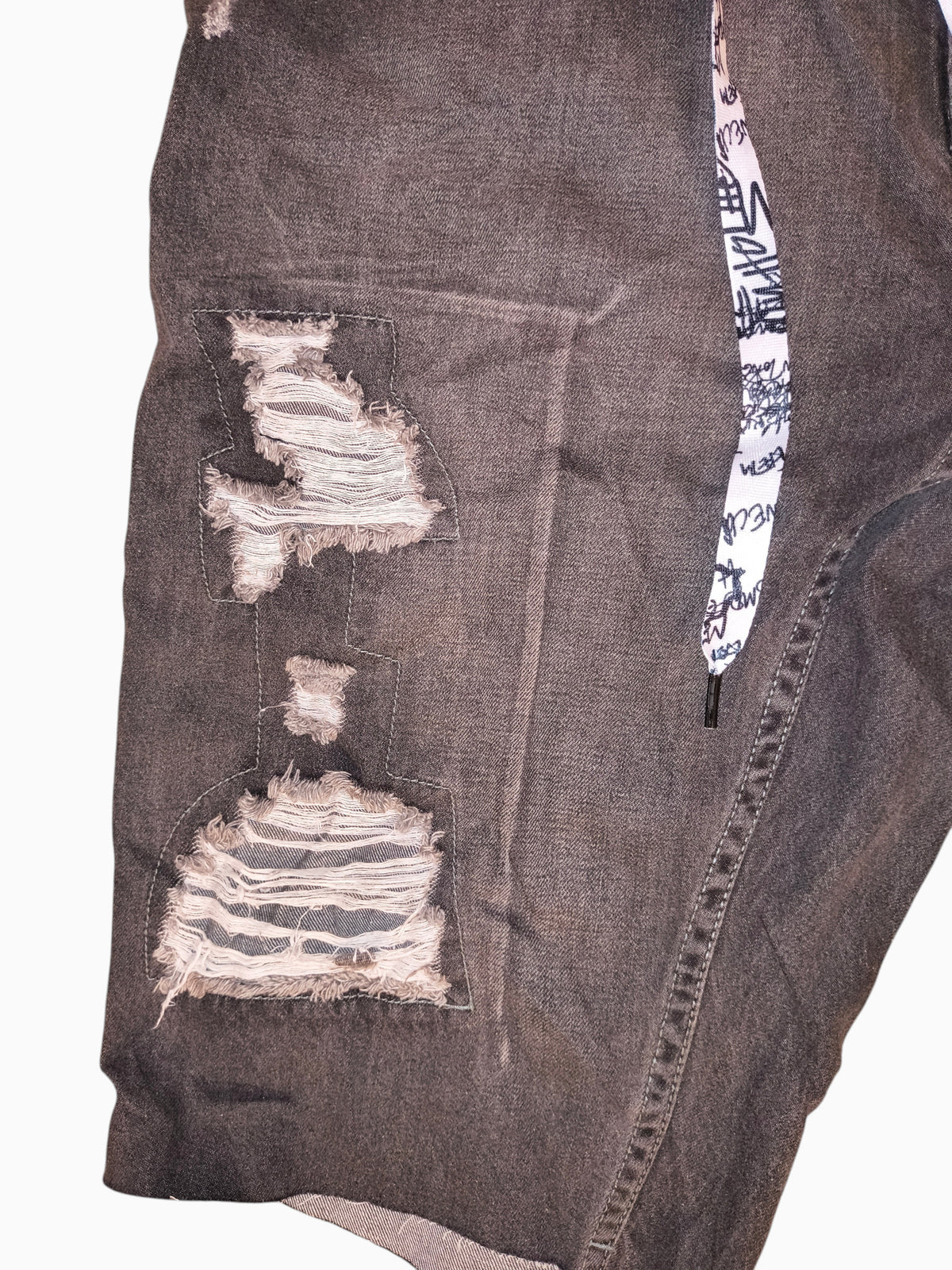 Awsum Thrift Trukfit grey distressed denim shorts with shredded panels and graphic print drawstring