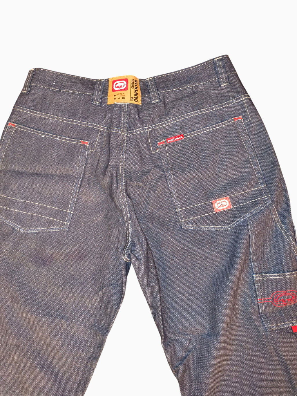 Awsum Thrift vintage Marc Ecko dark indigo denim carpenter jeans with red contrast stitching and rhino logo details.