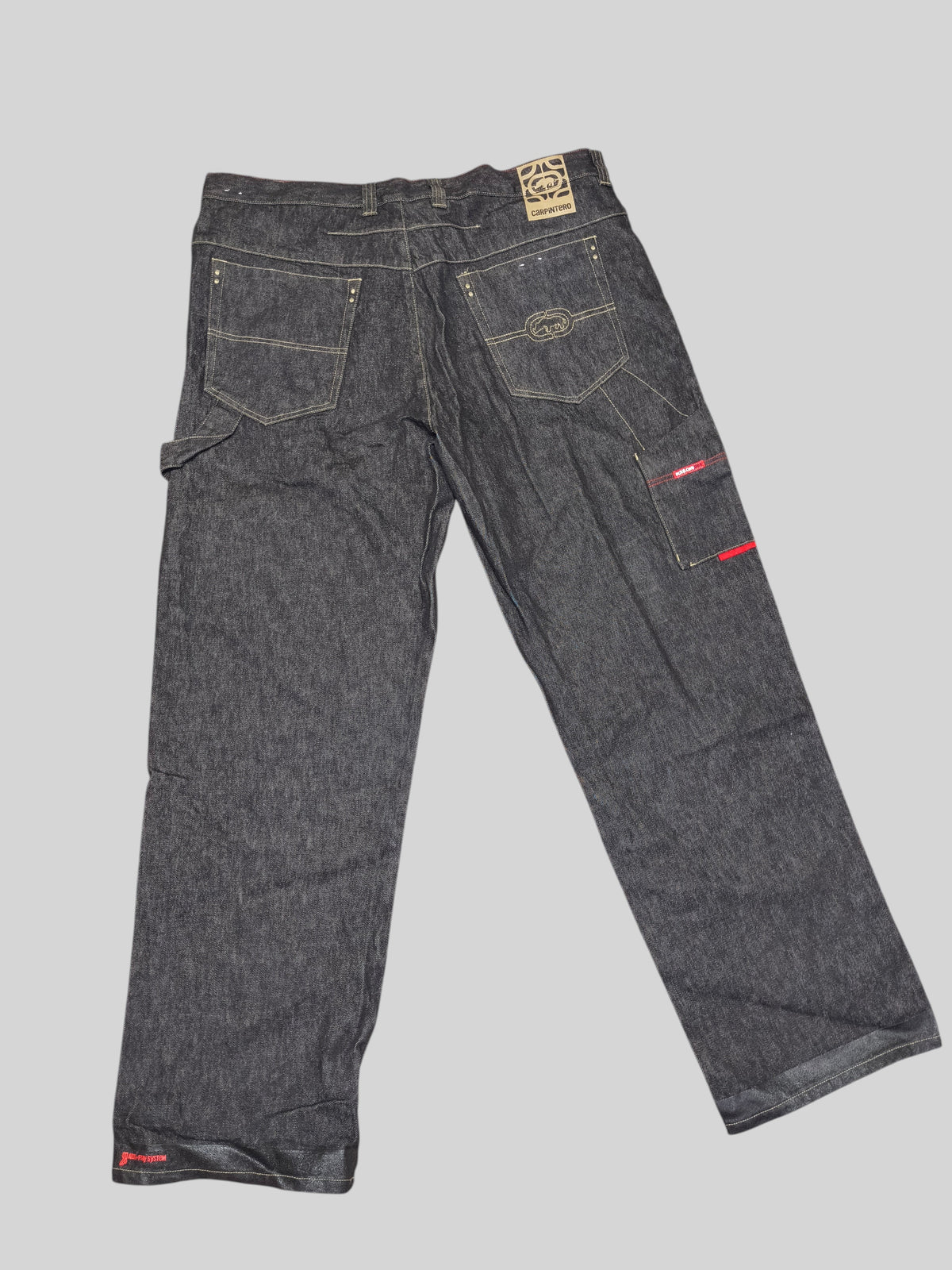Awsum Thrift Ecko dark wash denim carpenter jeans with back pockets, hammer loop, and non-slip hem detailing.