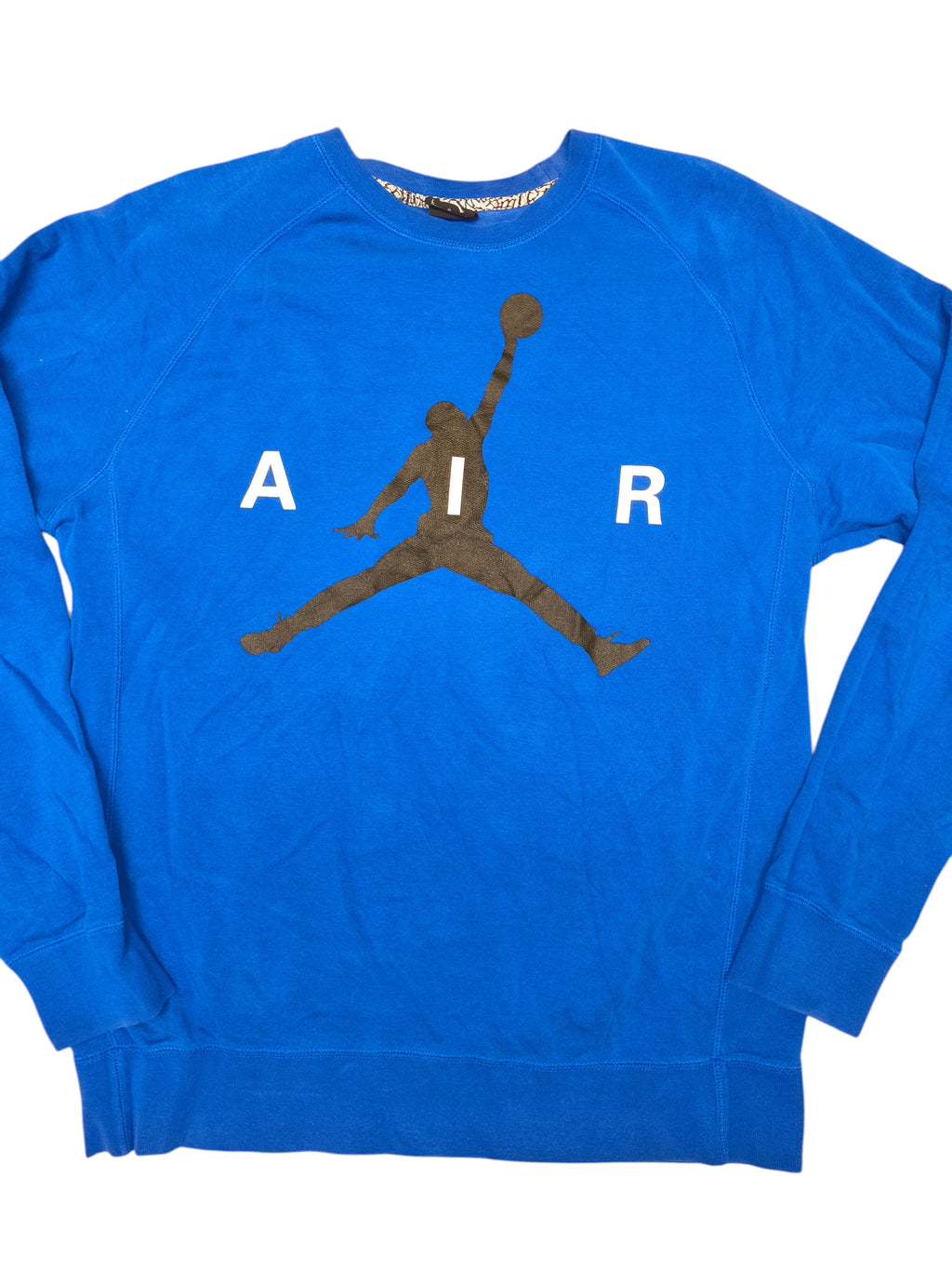 Awsum Thrift blue Jordan crewneck sweatshirt featuring a black Jumpman logo and white AIR lettering on the chest.