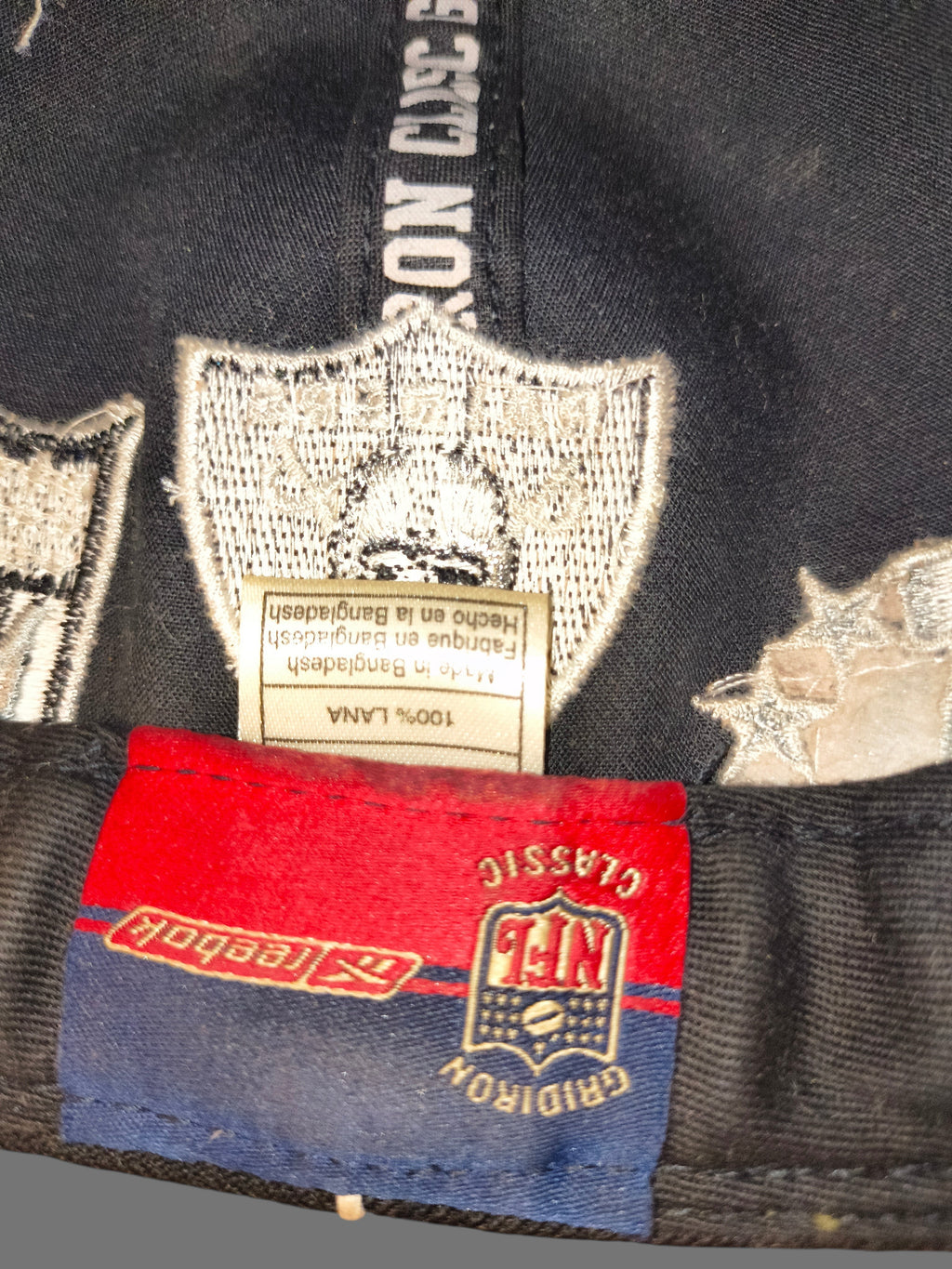 Awsum Thrift vintage Reebok Raiders wool hat interior tag showing NFL Gridiron Classics branding and material details