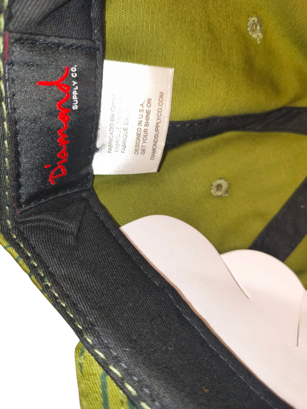Awsum Thrift Diamond Supply Co. snapback hat interior showing brand label and olive green rain camo fabric