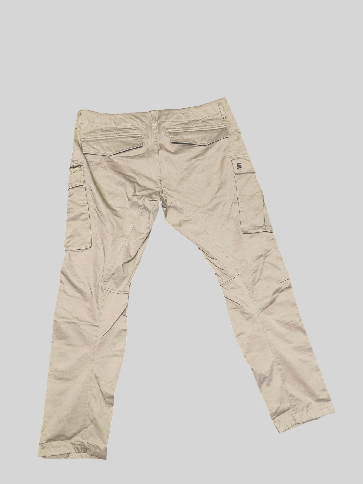 Awsum Thrift G-Raw beige cargo pants featuring back flap pockets and side utility pockets in a durable cotton fabric.