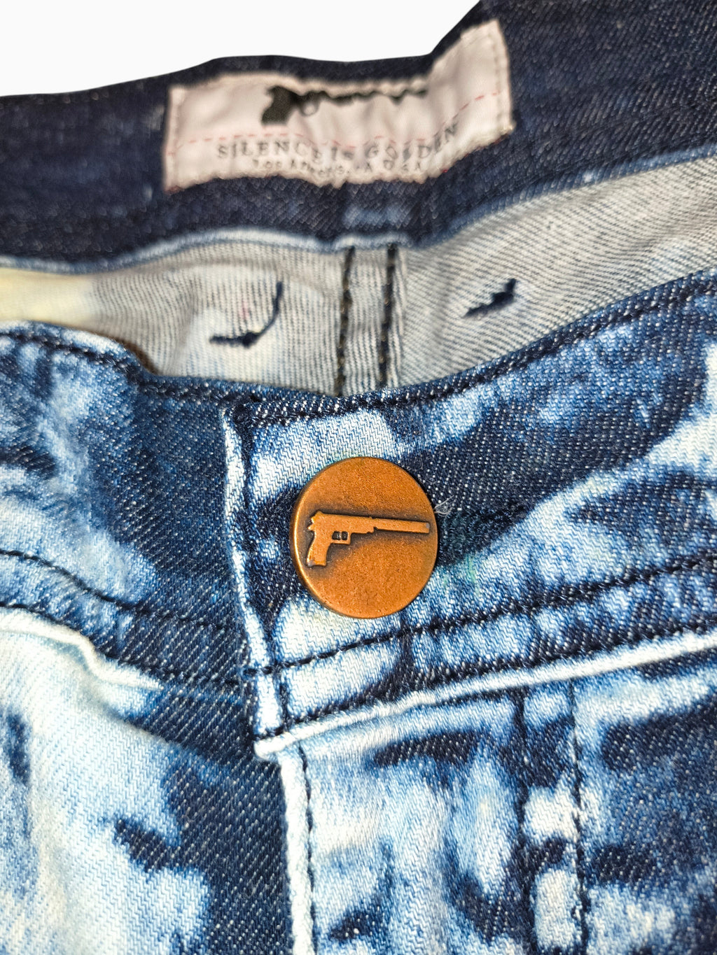 Awsum Thrift Golden Denim The Clark slim fit jeans featuring a copper button with a pistol logo and bleached wash