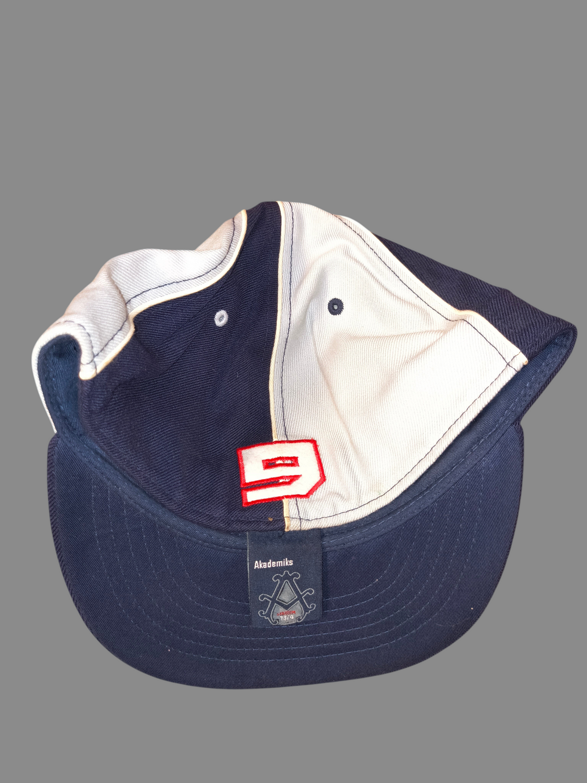 Awsum Thrift vintage Akademiks navy and grey two-tone fitted hat with red number 9 patch on the back