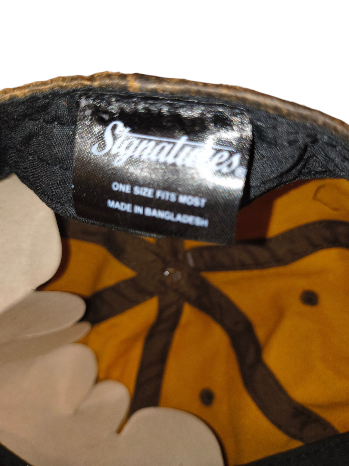 Awsum Thrift Signatures dad hat interior label showing brand logo, size, and origin on brown waxed faux leather fabric