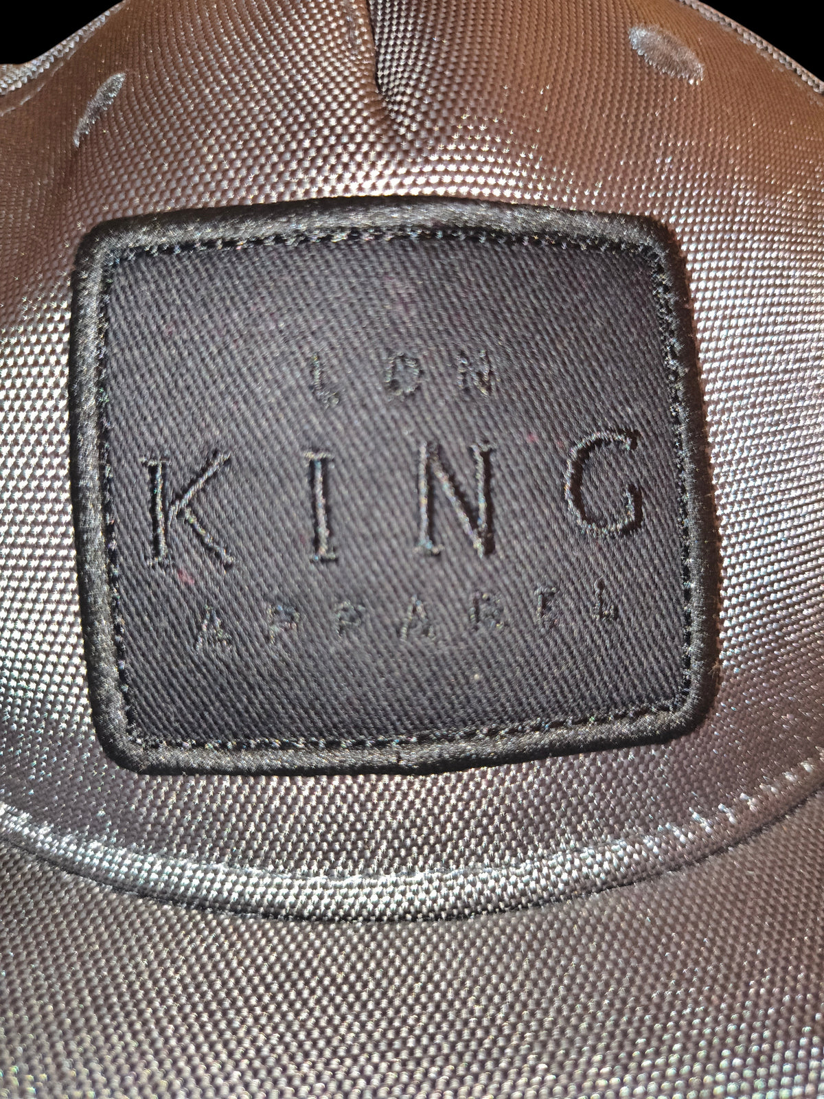 Awsum Thrift King Hat featuring a black rectangular patch with embroidered lettering on a grey textured fabric cap.