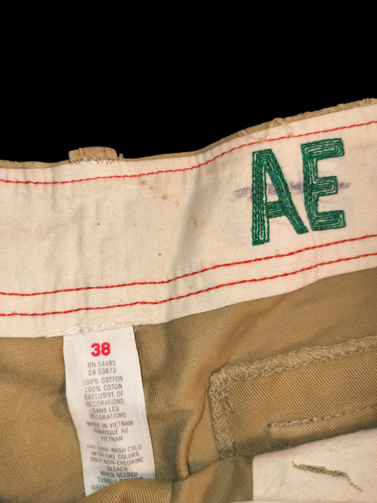 Awsum Thrift American Eagle Outfitters khaki cotton cargo shorts interior waistband with AE logo and size 38 tag