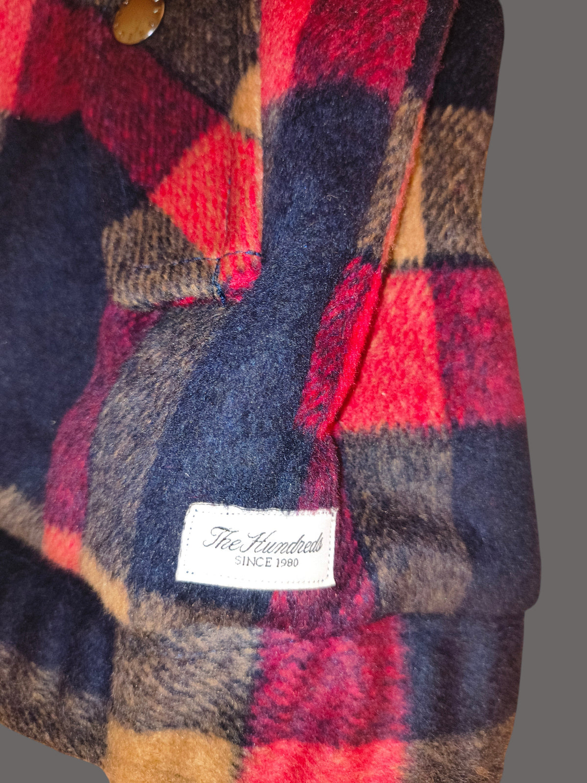 Awsum Thrift The One Hundred jacket in a red, navy, and tan plaid wool-blend fabric with a branded interior label