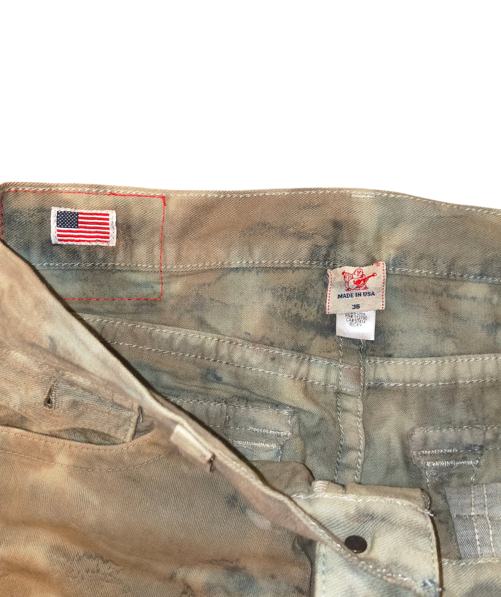 Awsum Thrift True Religion camo jeans featuring a USA flag patch and Made in USA label on the interior waistband