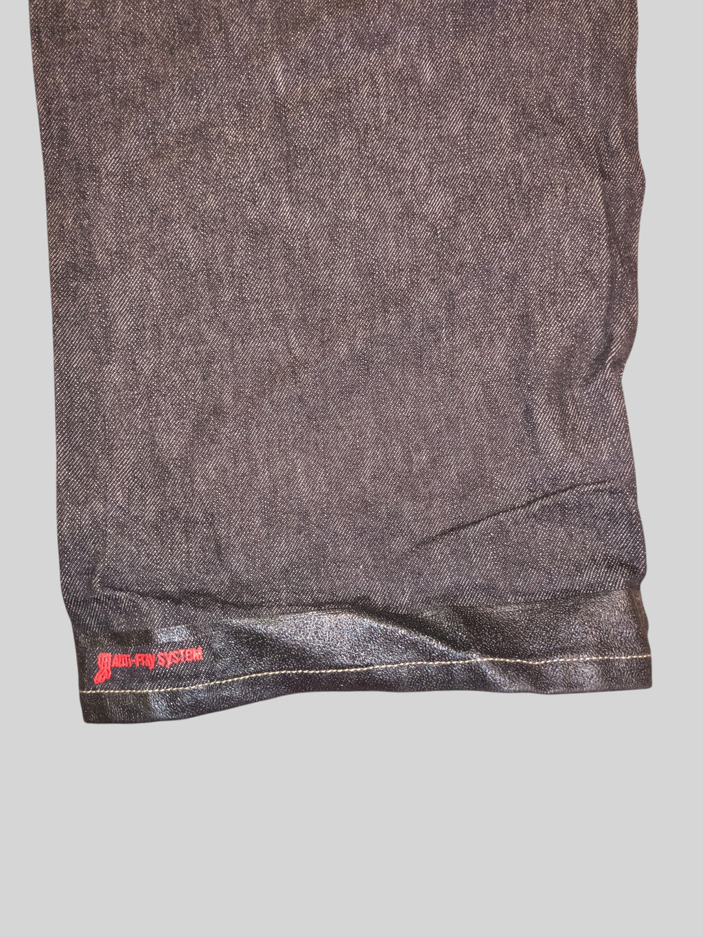 Awsum Thrift Ecko carpenter jeans featuring a dark denim fabric and a specialized non-slip hem with red branding