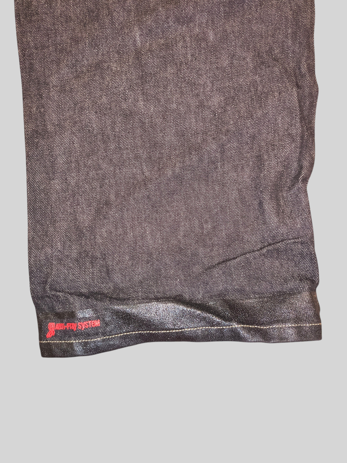 Awsum Thrift Ecko carpenter jeans featuring a dark denim fabric and a specialized non-slip hem with red branding