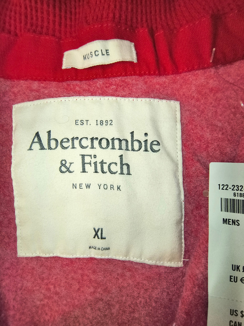 Awsum Thrift Abercrombie & Fitch clothing label showing size XL and Muscle fit tag on a white fabric background