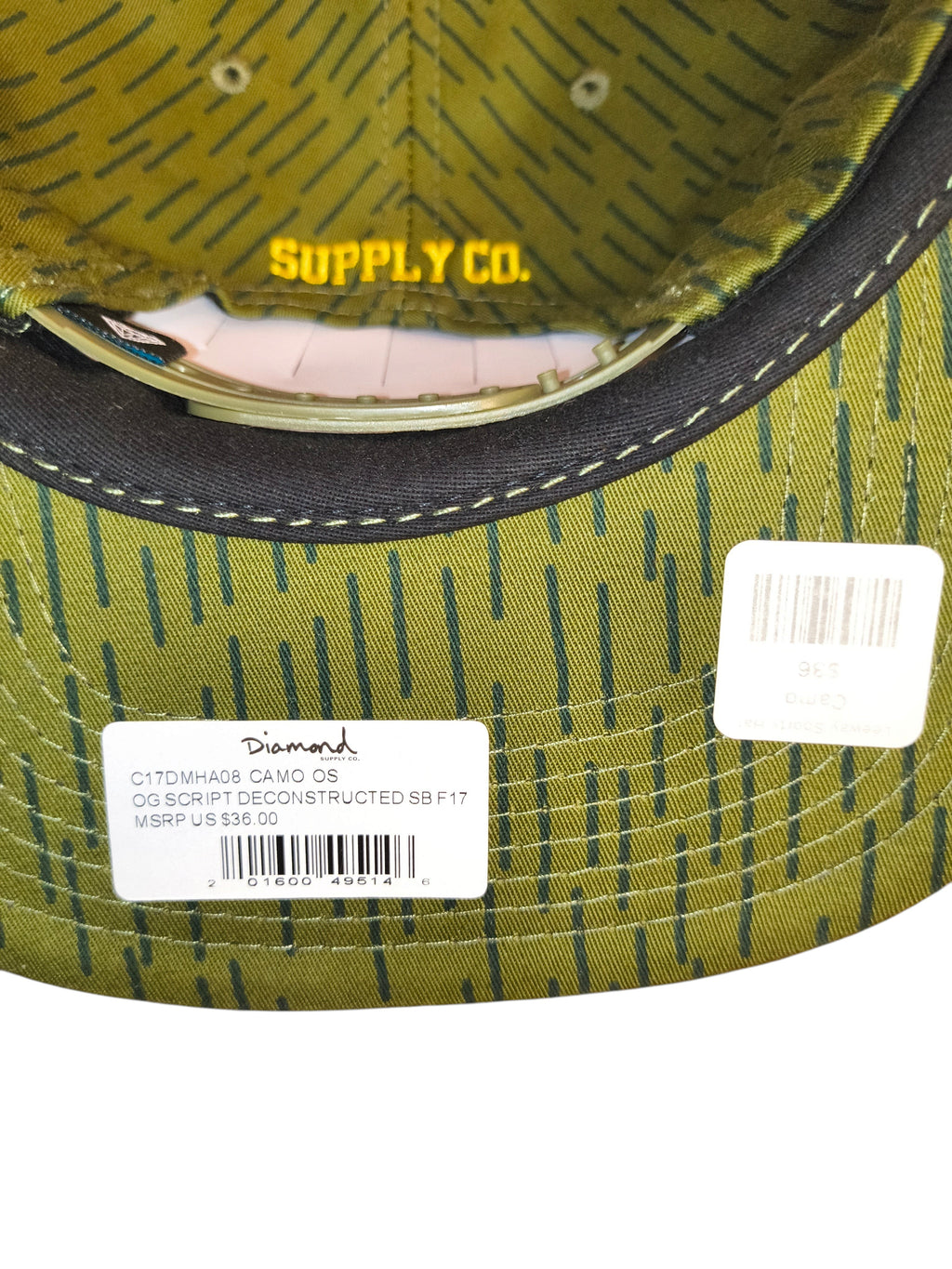 Awsum Thrift Diamond Supply Co. rain camo snapback hat with yellow logo embroidery and retail tags on the underside