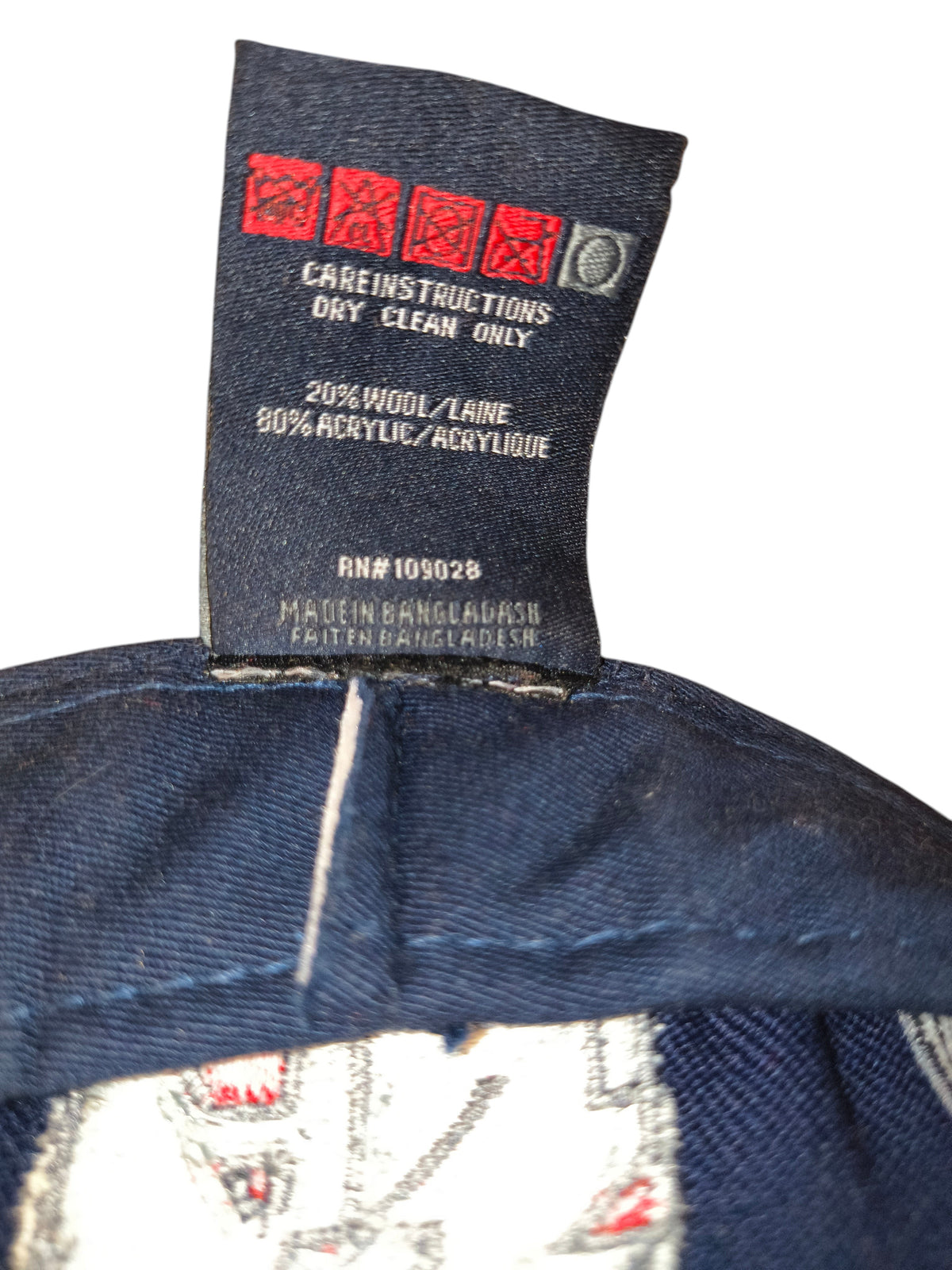 Awsum Thrift Akademiks vintage hat interior care tag showing 20 percent wool and 80 percent acrylic material blend