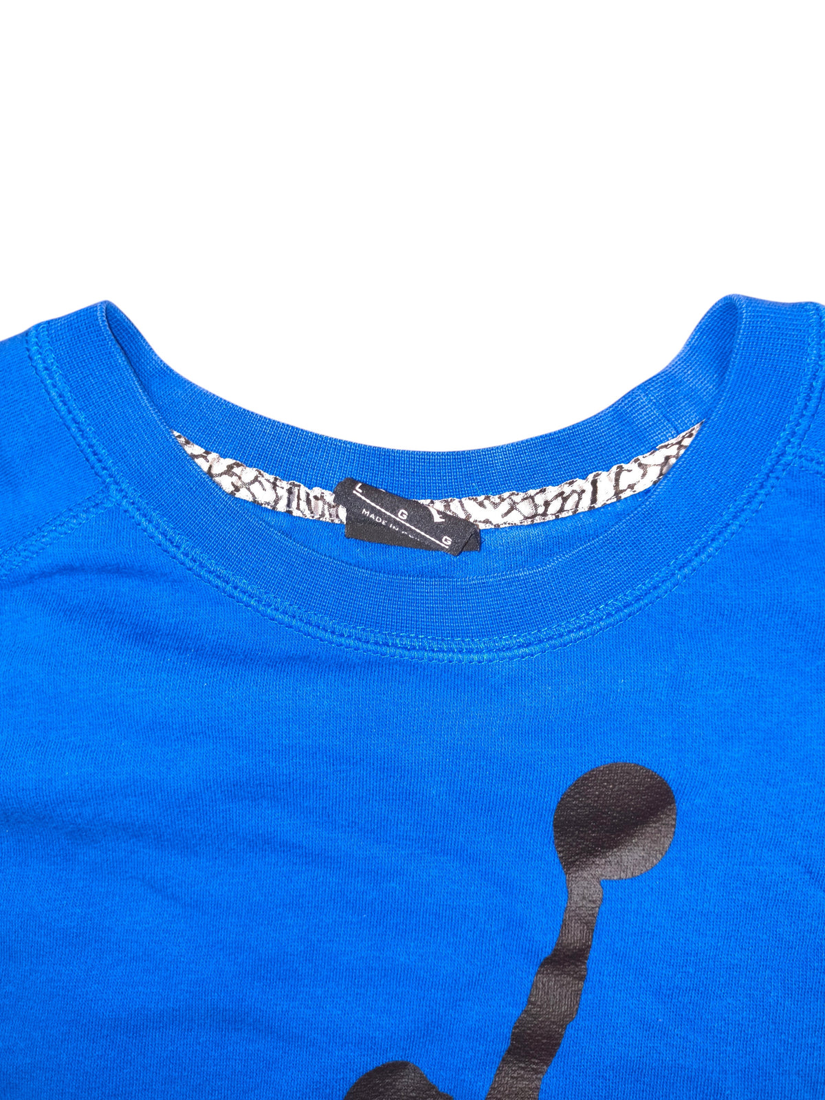 Awsum Thrift blue Jordan shirt featuring a black graphic and iconic elephant print trim on the inner collar