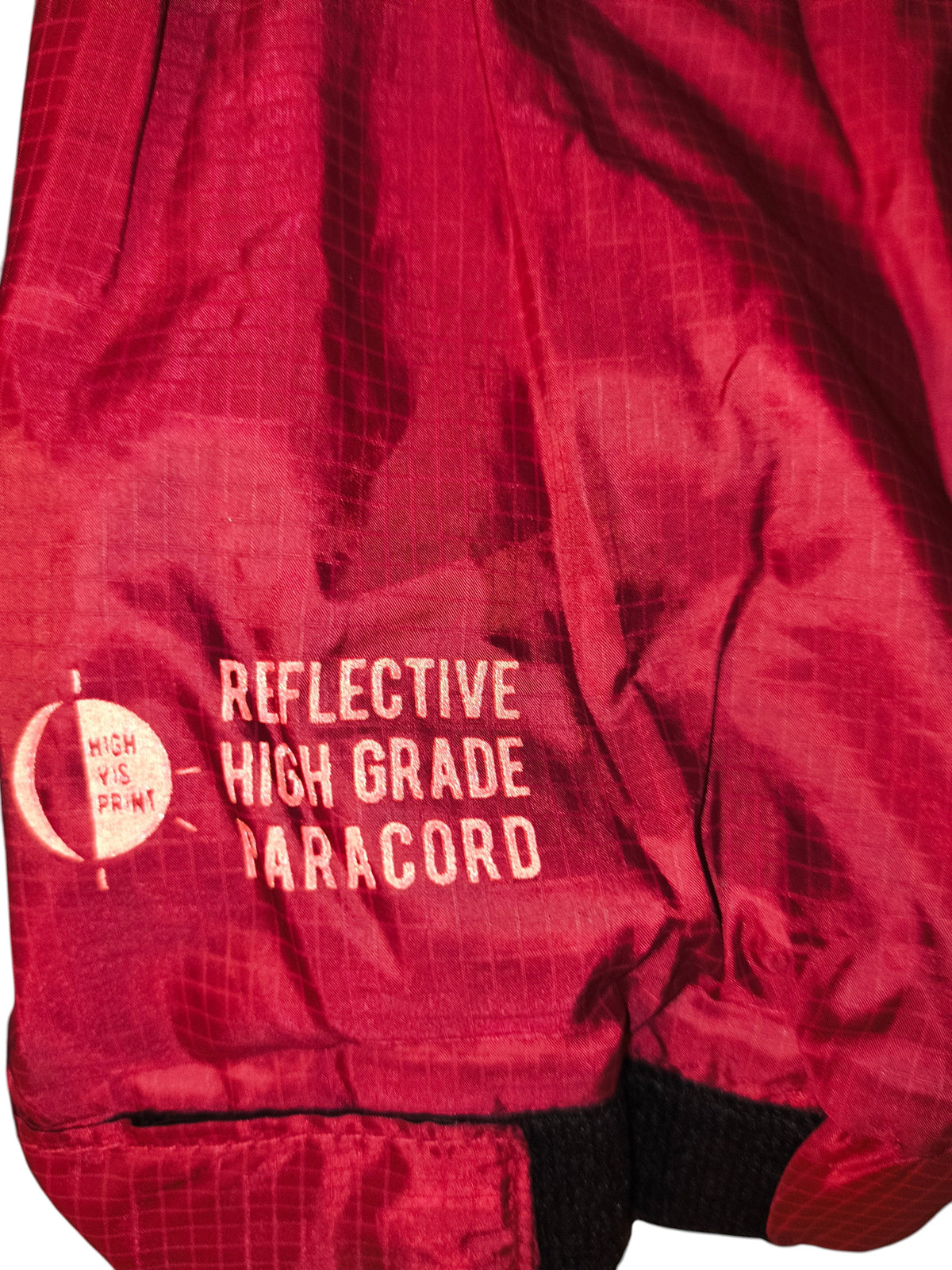 Awsum Thrift All Good burgundy ripstop windbreaker sleeve detail with reflective high-visibility print text