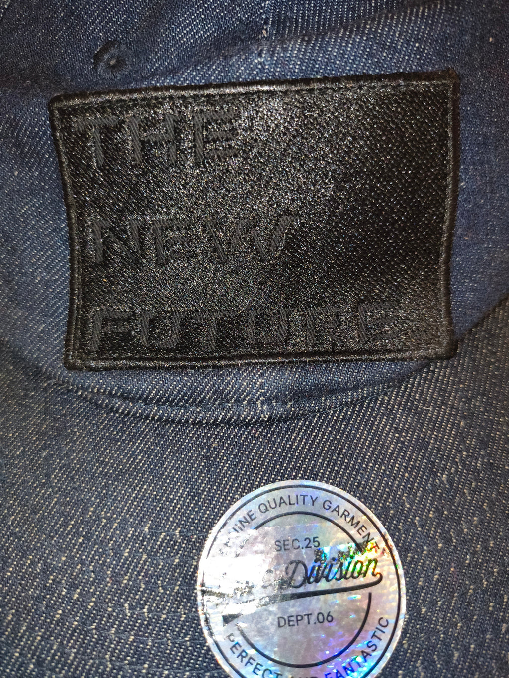 Awsum Thrift H&M blue denim snapback hat featuring a black embroidered The New Future patch and a circular sticker.