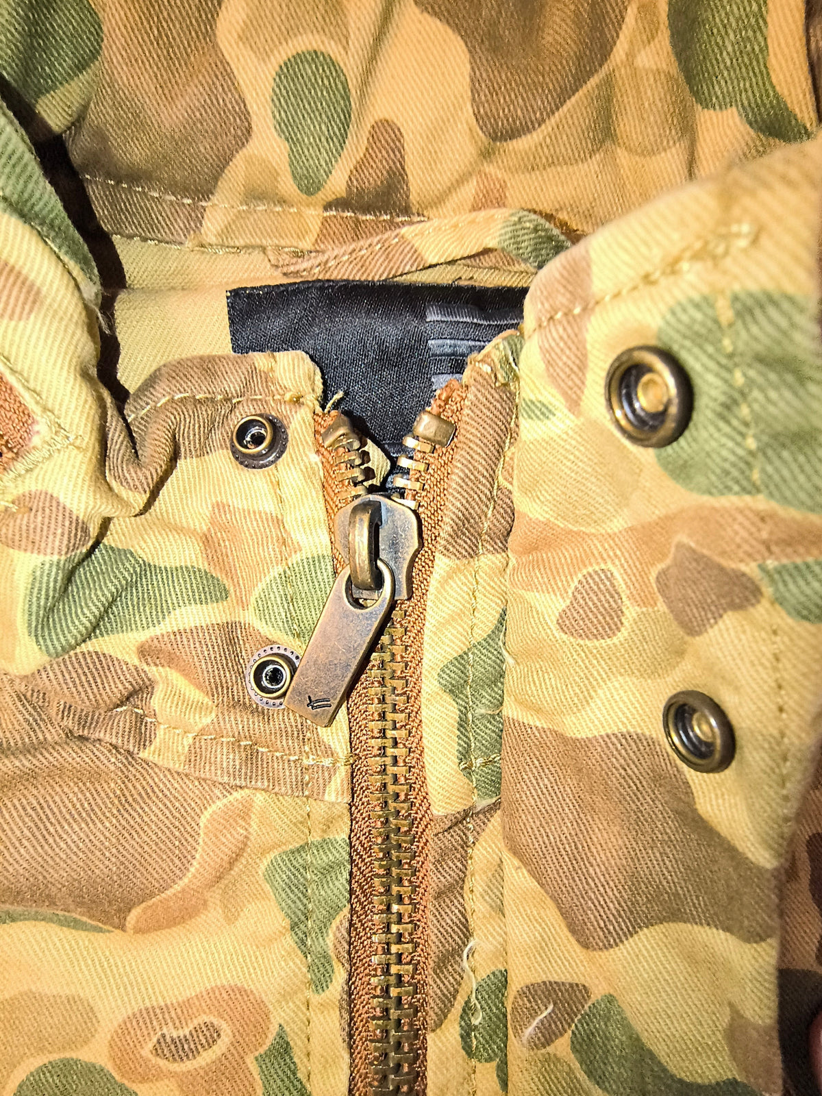 Awsum Thrift William Rast duck hunter camo field jacket featuring a metallic zipper and snap button collar detail.