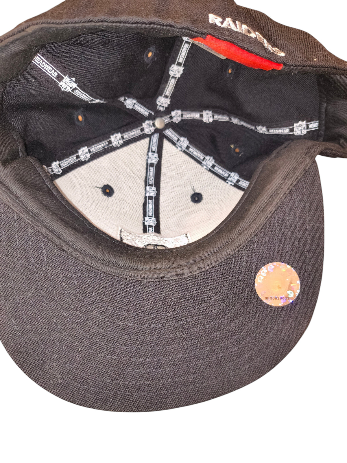 Awsum Thrift vintage Reebok Raiders fitted hat interior showing NFL branded taping and holographic visor sticker