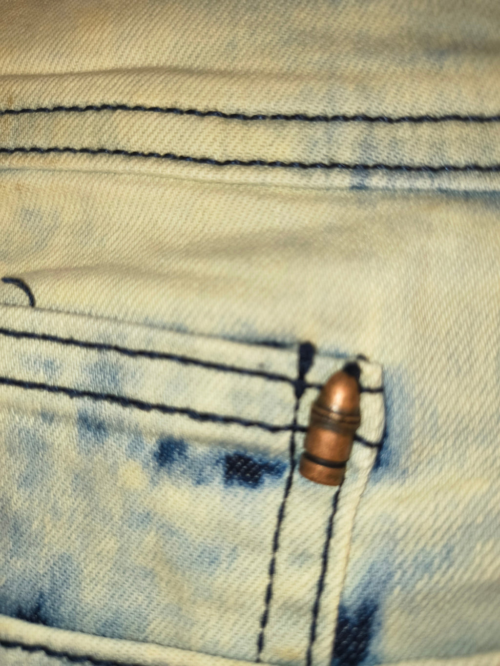 Awsum Thrift Golden Denim bleached indigo tie-dye jeans featuring a copper bullet watch pocket rivet detail.