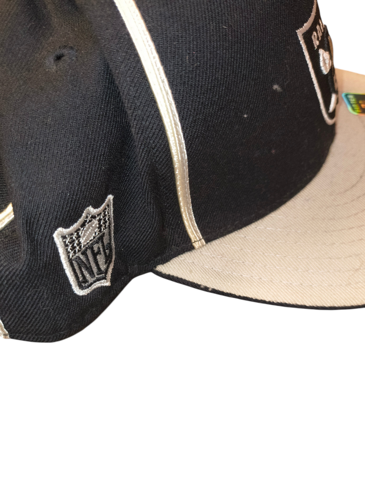 Awsum Thrift vintage Reebok Raiders fitted hat featuring a black crown, grey visor, white piping, and NFL logo detail.