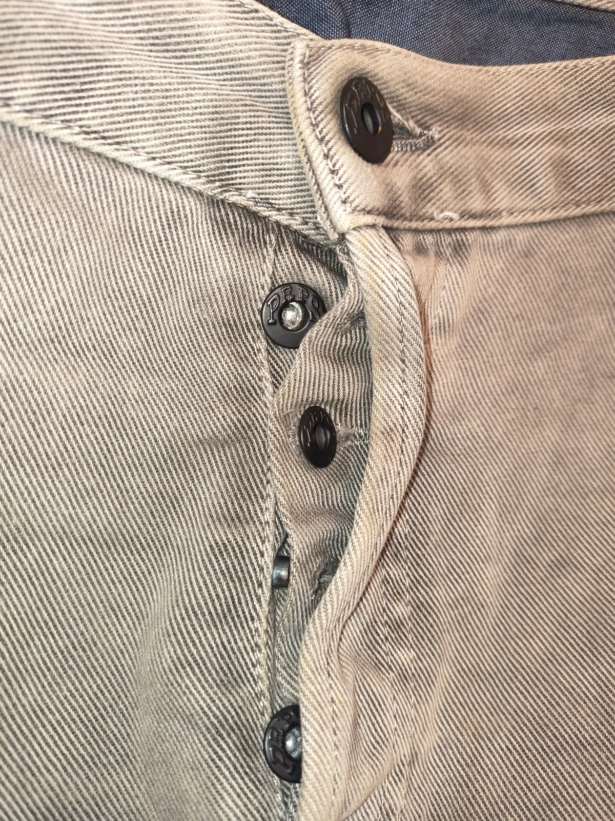 Awsum Thrift PRPS gray denim jeans featuring a classic button fly closure with branded metal buttons