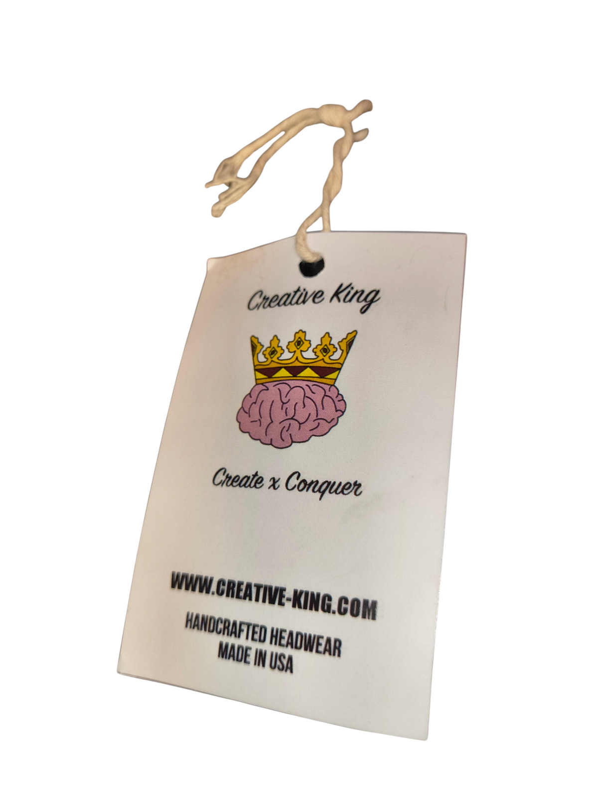 Awsum Thrift Creative King Hat Co. brand hang tag featuring a crown and brain logo with Create x Conquer text