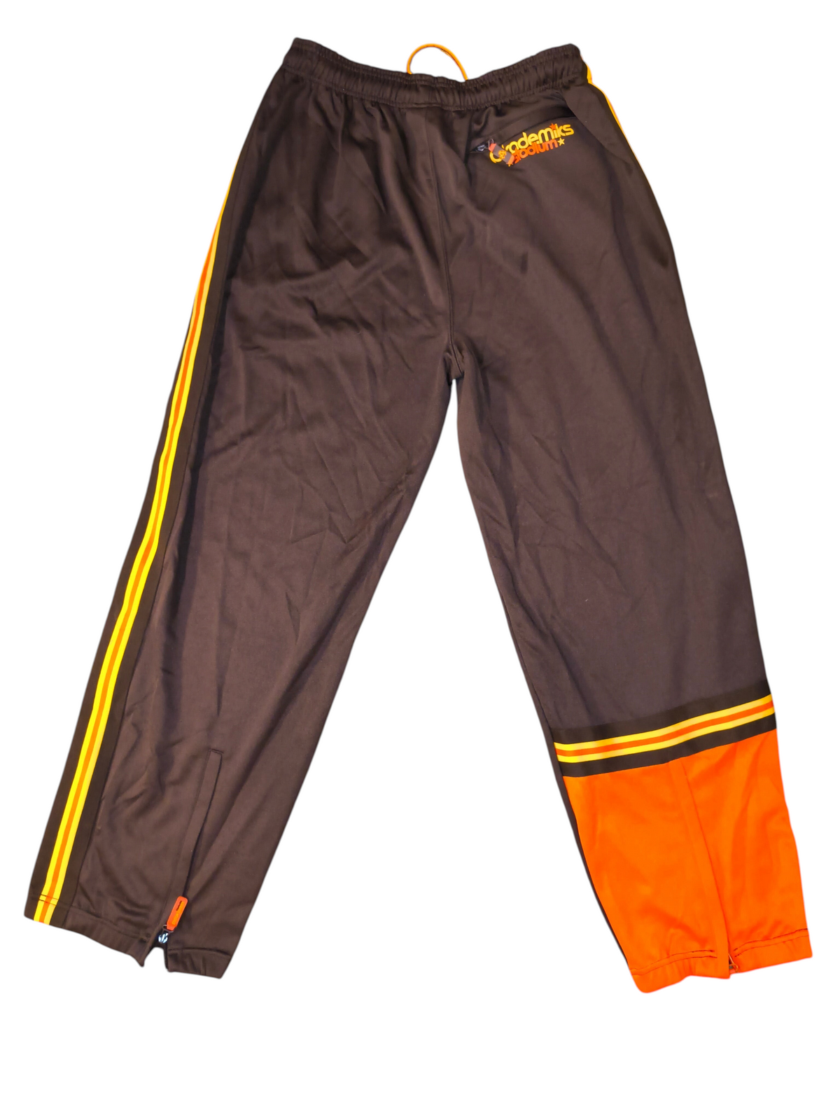 Awsum Thrift vintage Akademiks brown polyester track pants with orange side stripes and logo patch, size XXL