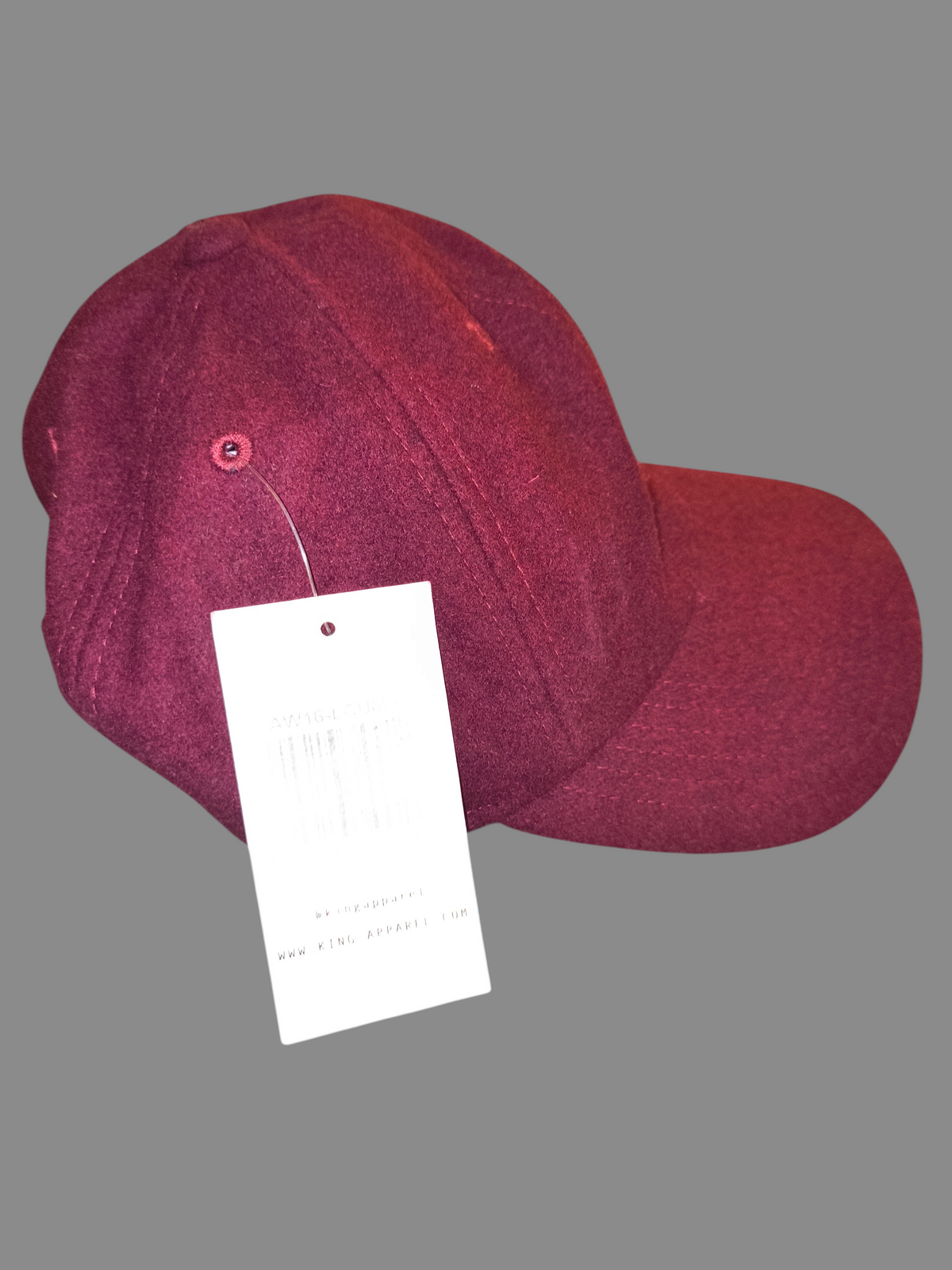 Awsum Thrift King Apparel maroon wool-blend dad hat with a white retail tag attached, side profile view.