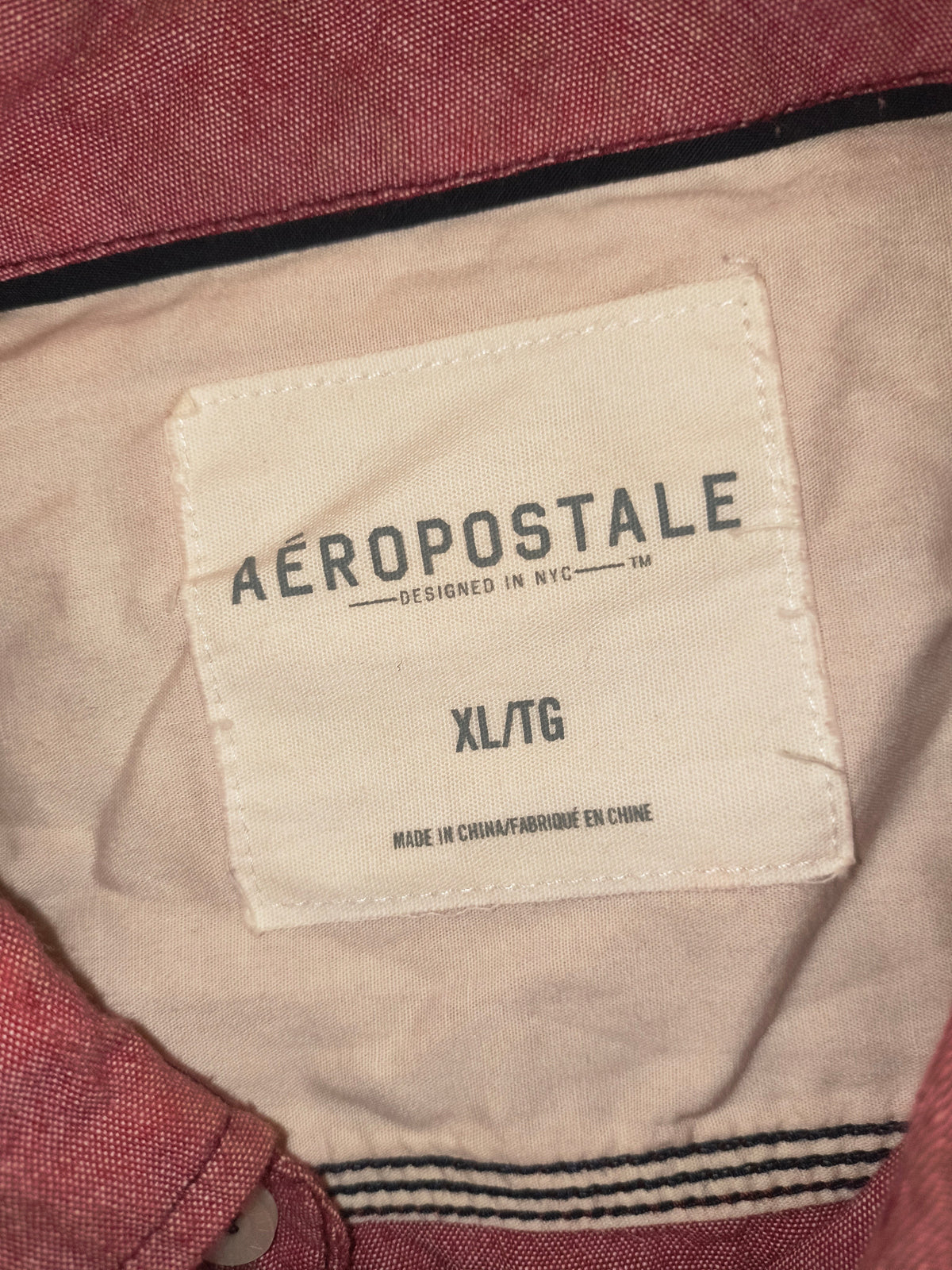 Awsum Thrift Aeropostale button up shirt label showing size XL TG on a light pink and white fabric background