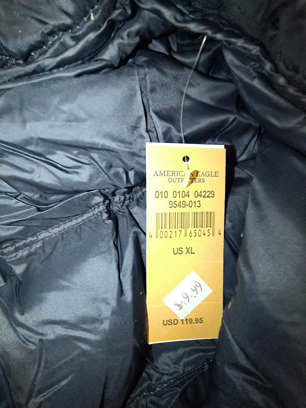 Awsum Thrift American Eagle Outfitters men's XL puffer jacket retail price tag attached to dark navy interior lining
