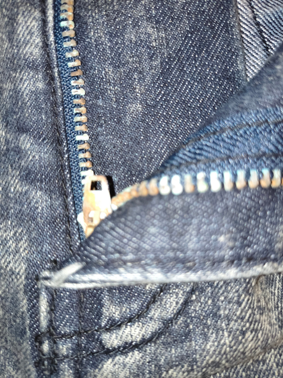 Awsum Thrift Decibel black stone washed denim shorts featuring a detailed view of the metal zipper fly and stitching.