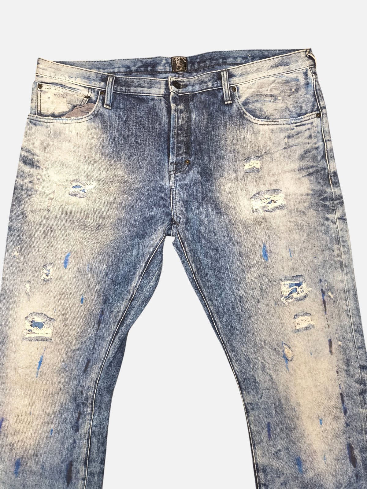 Awsum Thrift PRPS jeans in distressed blue denim with paint splatter details and ripped knees