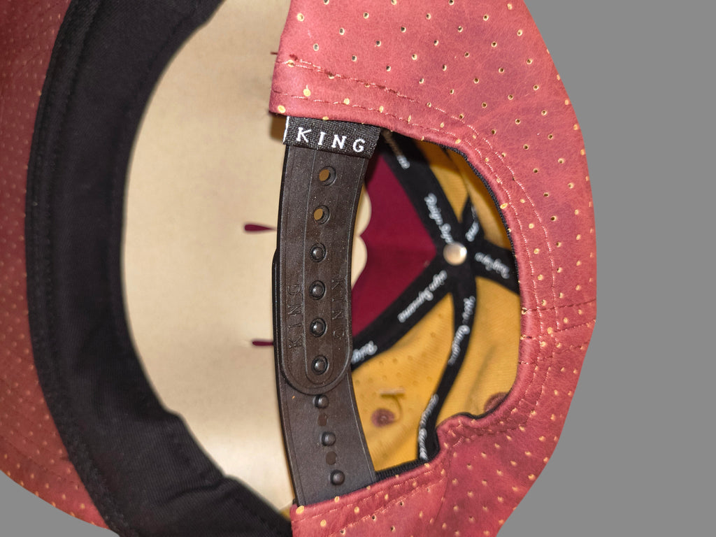 Awsum Thrift King Apparel maroon perforated faux-leather snapback hat with black adjustable strap and interior branding
