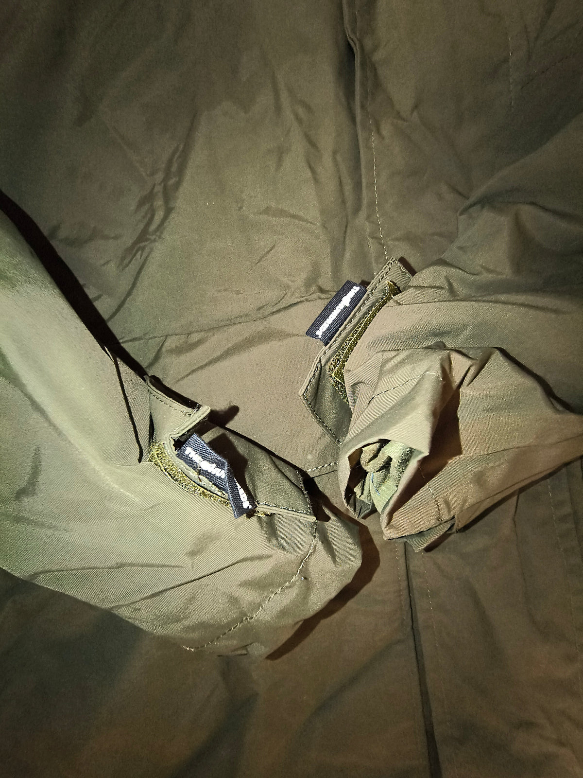 Awsum Thrift olive green water-resistant technical jacket sleeve detail with adjustable velcro cuffs